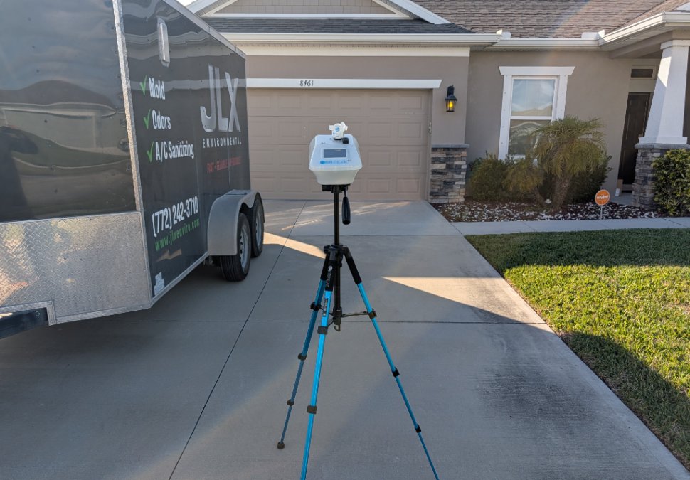 Outdoor air sampling being performed with professional air-testing equipment as part of JLX mold and indoor air quality testing.