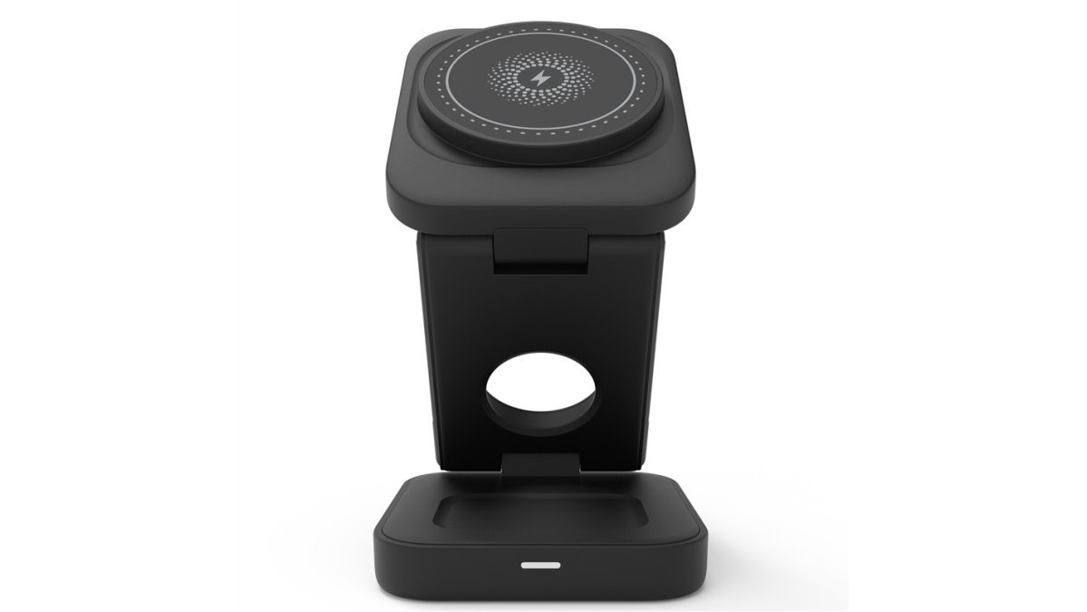 Close-up of a compact foldable 3-in-1 wireless charger folded and unfolded next to a kitchen counter with a smartphone, smartwatch, and earbuds charging simultaneously on the unfolded station