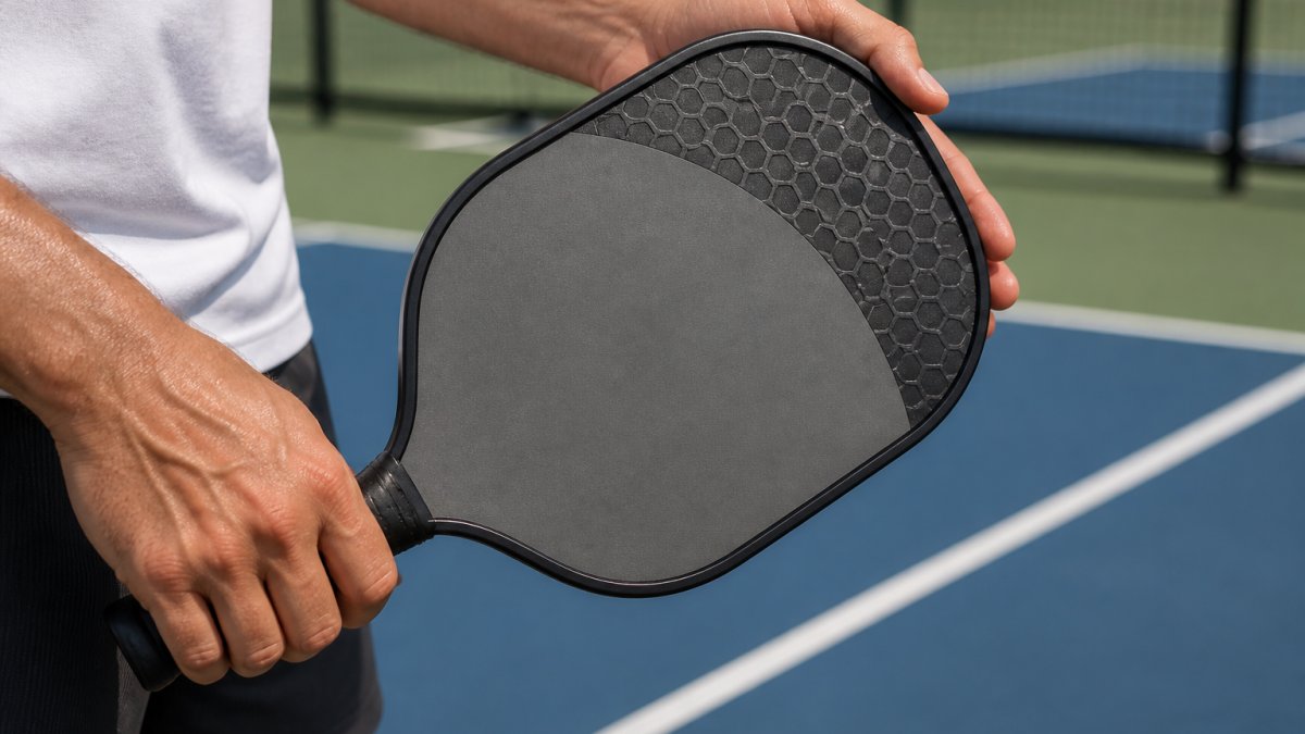 Diagram illustrating the honeycomb structure of a pickleball paddle core and its shock absorption process.