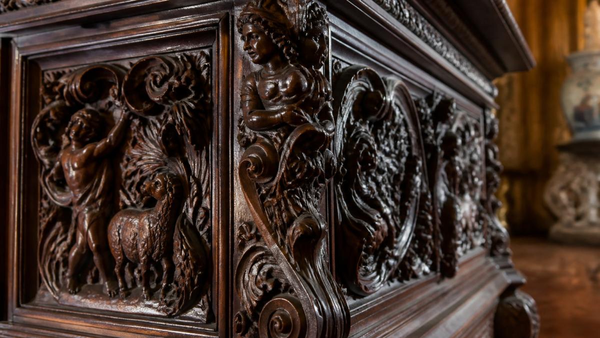 Diagram highlighting ornate scrollwork and acanthus leaf carvings on antique walnut furniture pieces.