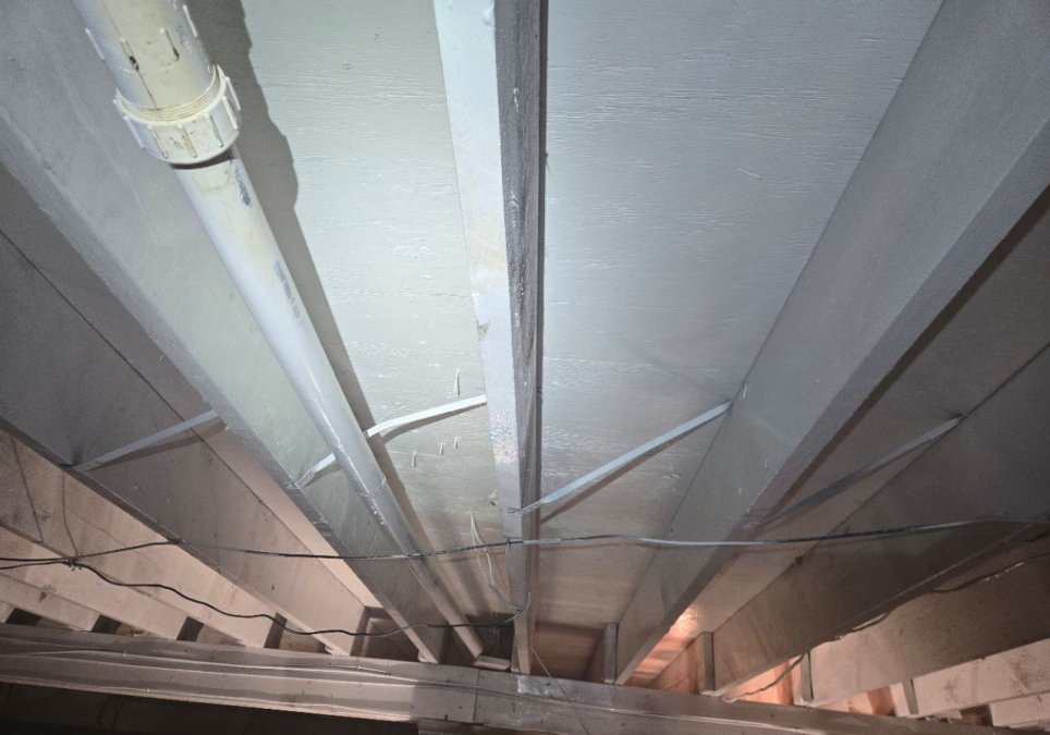Exposed crawlspace floor framing after treatment during a JLX crawlspace mold remediation project.