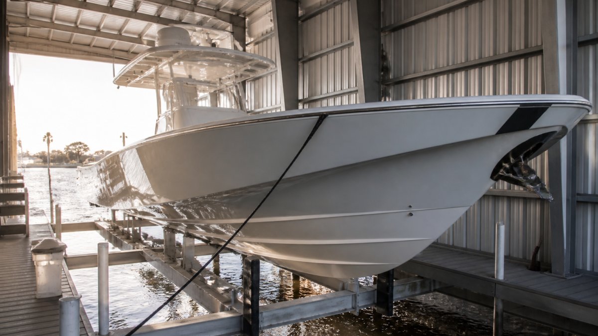 Center console yacht secured in a covered marina lift, qualifying for boat insurance discounts during storage.