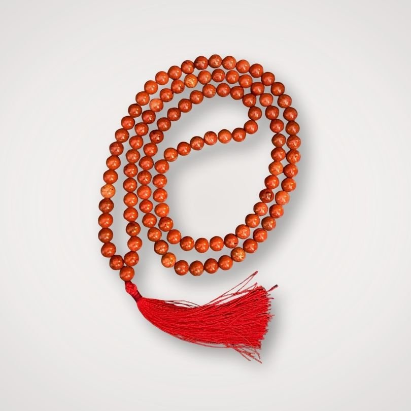 Red jasper mala with polished gemstone beads for meditation and intention setting.
