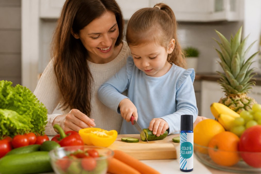 A parent and young child in a bright kitchen preparing fresh vegetables and fruits together, with colorful produce on the counter and a cutting board visible