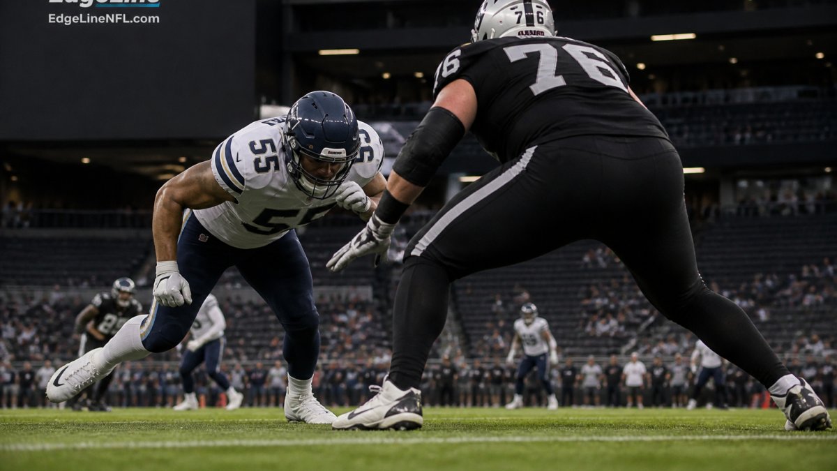 Edge rusher in a low stance exploding off the line to improve pass rush win rate during a stadium night game
