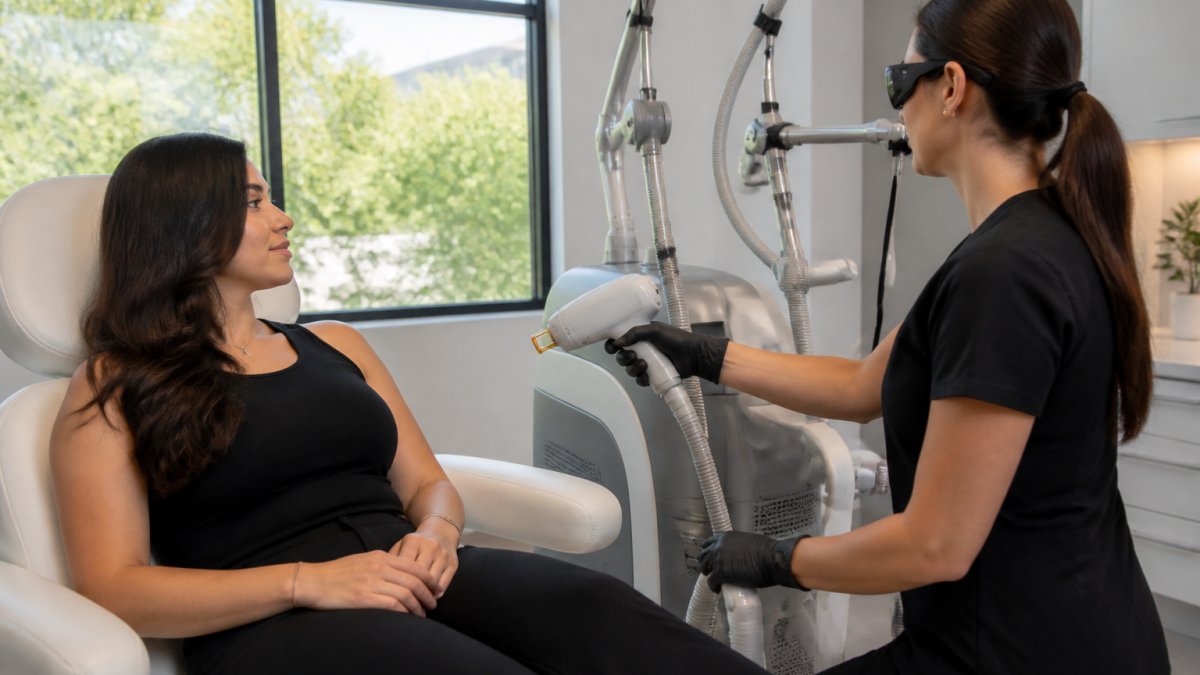 Aesthetic practitioner using a laser device to improve aesthetic clinic profit margins for a seated patient