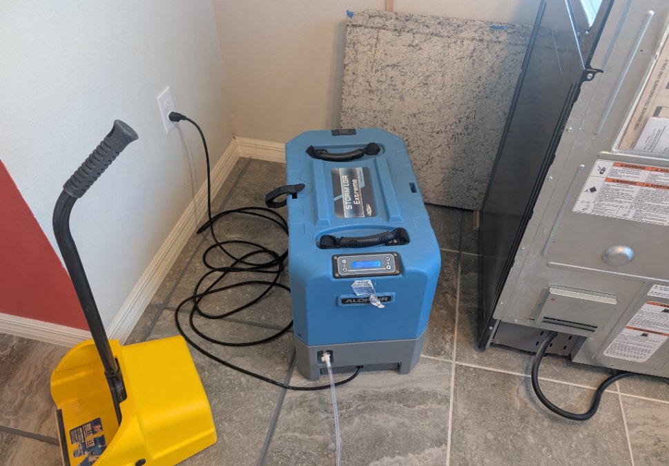 Professional dehumidifier operating inside a residential JLX mold remediation work area to help control moisture conditions during the project.