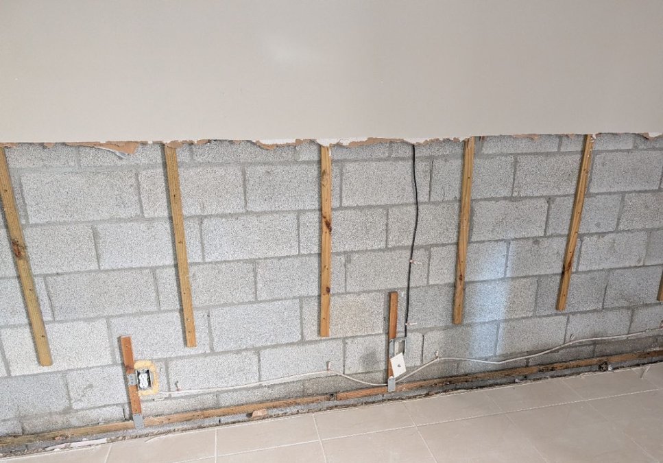Exposed and cleaned concrete-block wall after removal of affected materials during mold remediation.