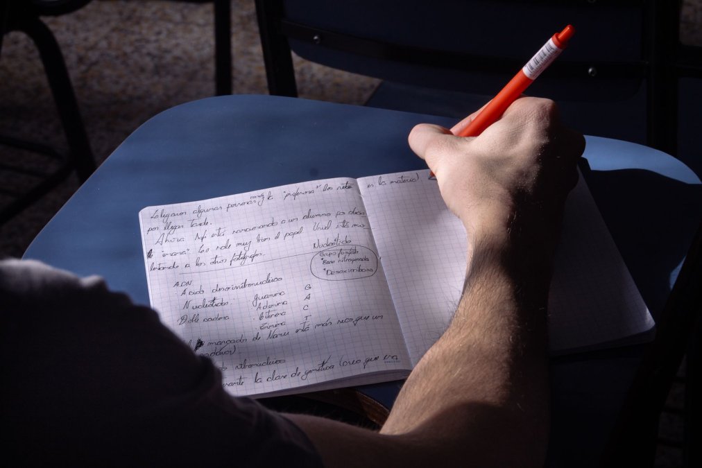Signs of Authentic Psychic Medium Guidance 2 a student takes notes in a classroom in buenos aires natural lighting highlights the writing process stock 1786493575