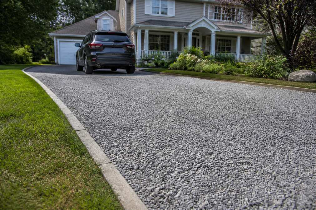 Diagram illustrating the budget-friendly process of gravel driveway paving for a suburban home landscape.