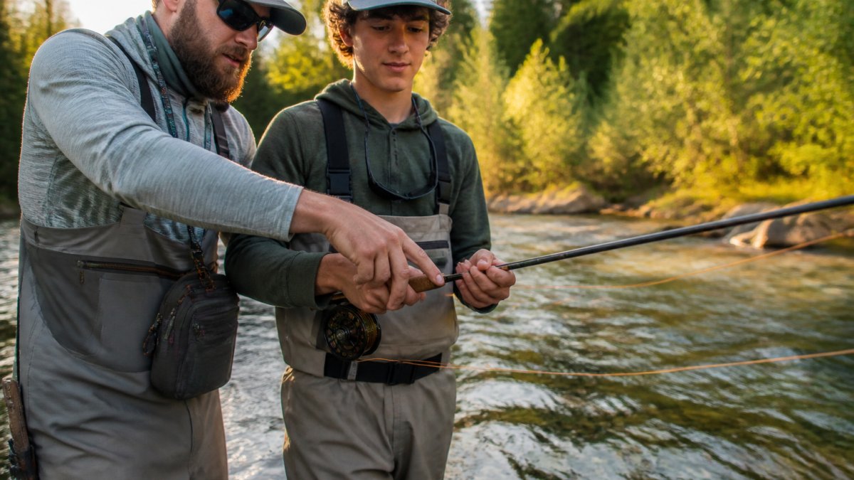 Professional guide teaching casting techniques to a student during affordable fly fishing guides lessons.