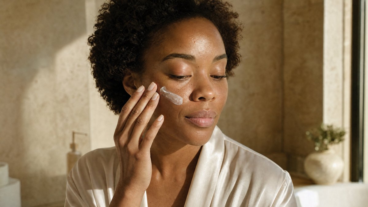 Agent Image A 40 Year Old Black Woman With Natural Skin Texture Stands In A Sunlit Luxury Bathroom