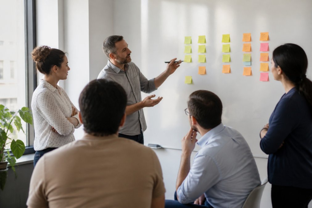 An agile coach facilitating a team retrospective, as seen in our agile guide vs hiring agile coach analysis.