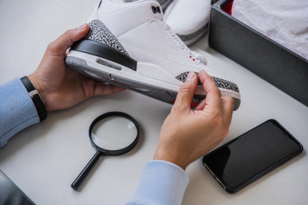 Step-by-step process for designer authentication by inspecting sneaker stitching, soles, and serial numbers.