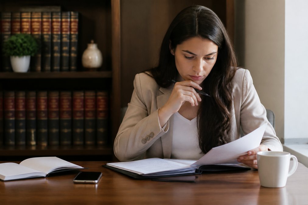 Person reviewing legal documents and considering alternatives to vacating a default judgment at a desk.