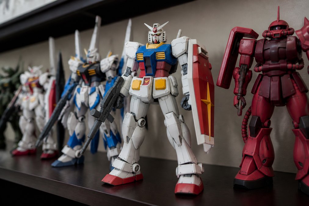 Completed entry grade Gundam model kit displayed on a shelf with visible panel line details and subtle custom paint accents on specific armor sections