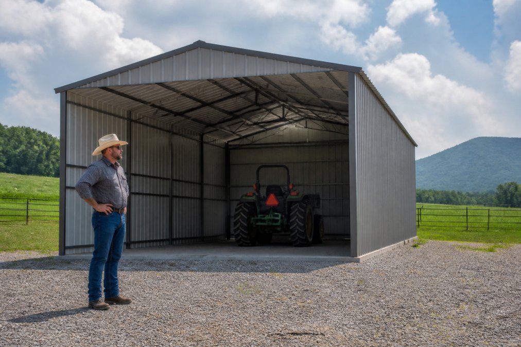 Rancher standing by a double-truss steel alternative shelter with a tractor parked inside on a rural property