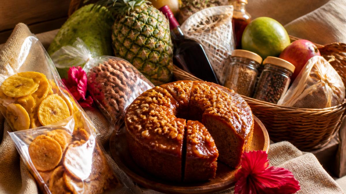 Handcrafted rum cake and artisanal ingredients featured in premium Caribbean food gift baskets on linen.