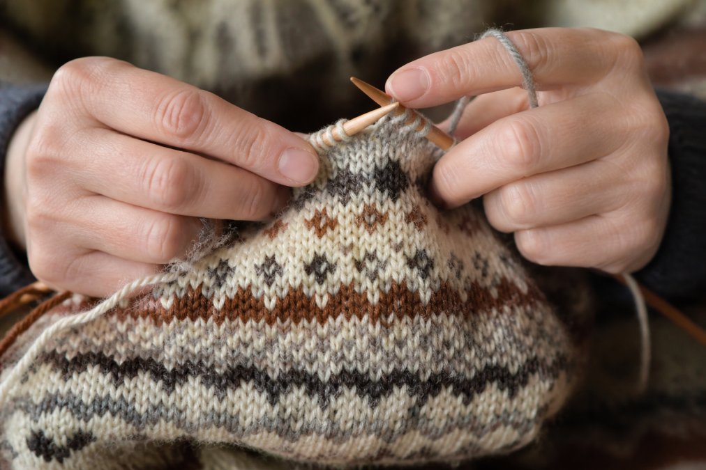 Diagram illustrating the knitting process of Fair Isle patterns using authentic Shetland wool in various shades