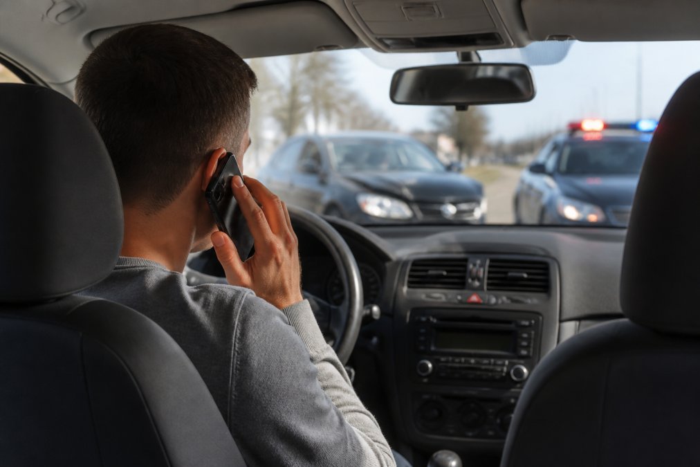 Driver calling for help after a minor crash as part of auto accident care