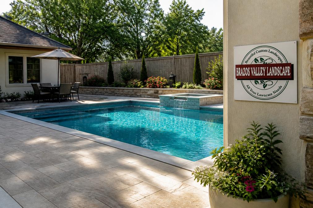 Rectangular concrete inground pool with stone patio and landscaping reflecting the cost of quality backyard design