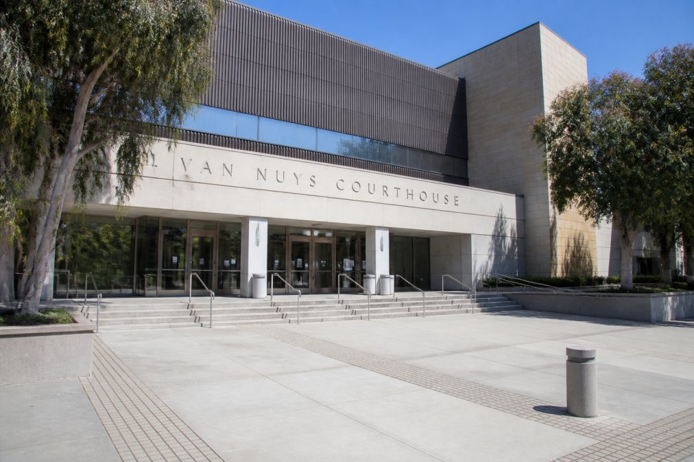 Exterior view of Van Nuys Courthouse building with clear signage and entrance, showing the modern facade and main entrance where defendants and families arrive for bail hearings, photographed during daytime with natural lighting