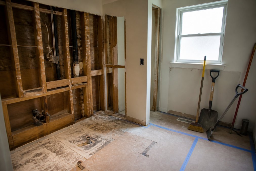 Bathroom mid-demolition with exposed studs and tools during professional bathroom renovations in Burnaby.