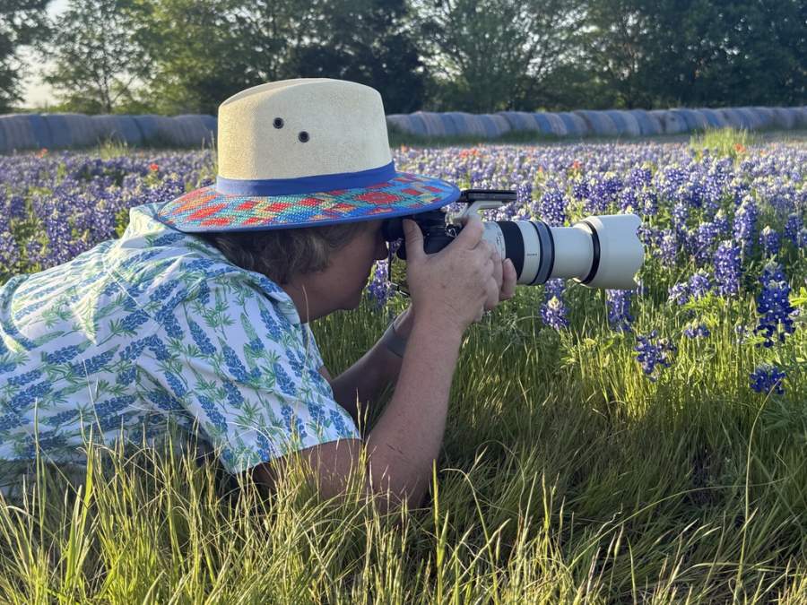 Angie getting down low during the Bluebonnet Photography workshop because there was a bird... Go figure!!