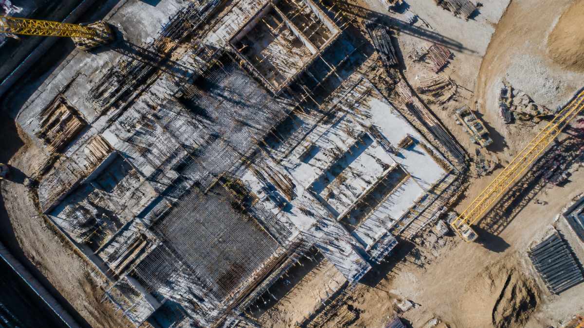 Aerial view of an active construction site captured for drone site monitoring of building progress and crews.