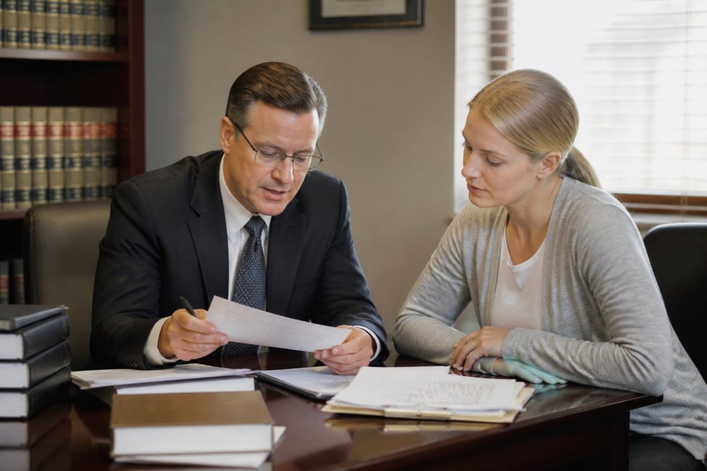 A professional attorney consulting with a client as the best bankruptcy lawyer in Nashua NH reviews documents.