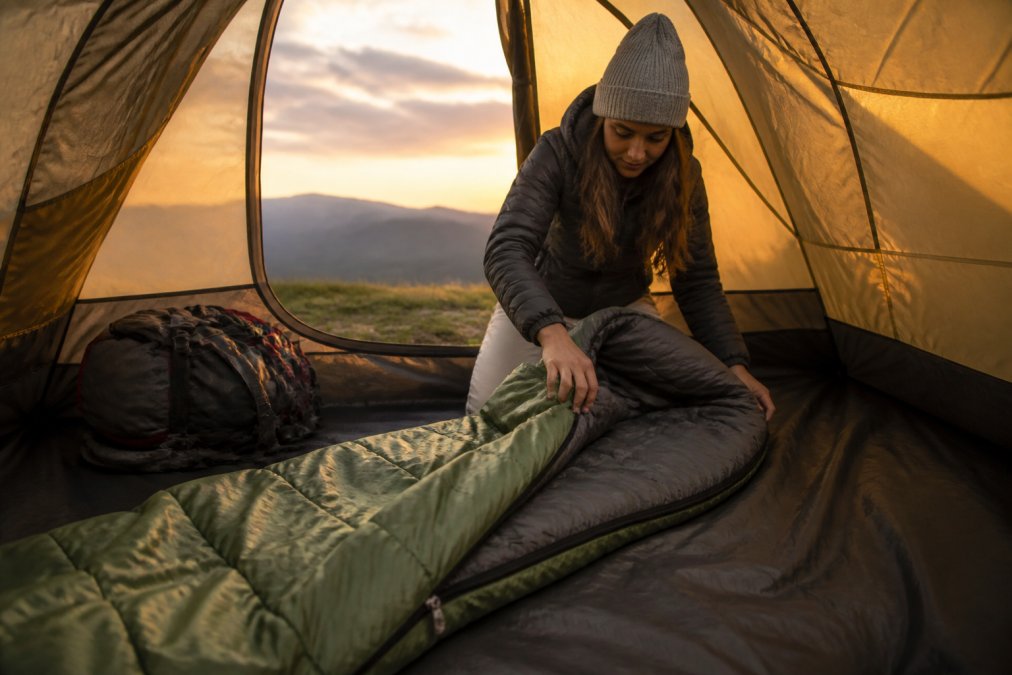 Infographic chart comparing top features of budget camping sleeping bags under 150 dollars for outdoor use.