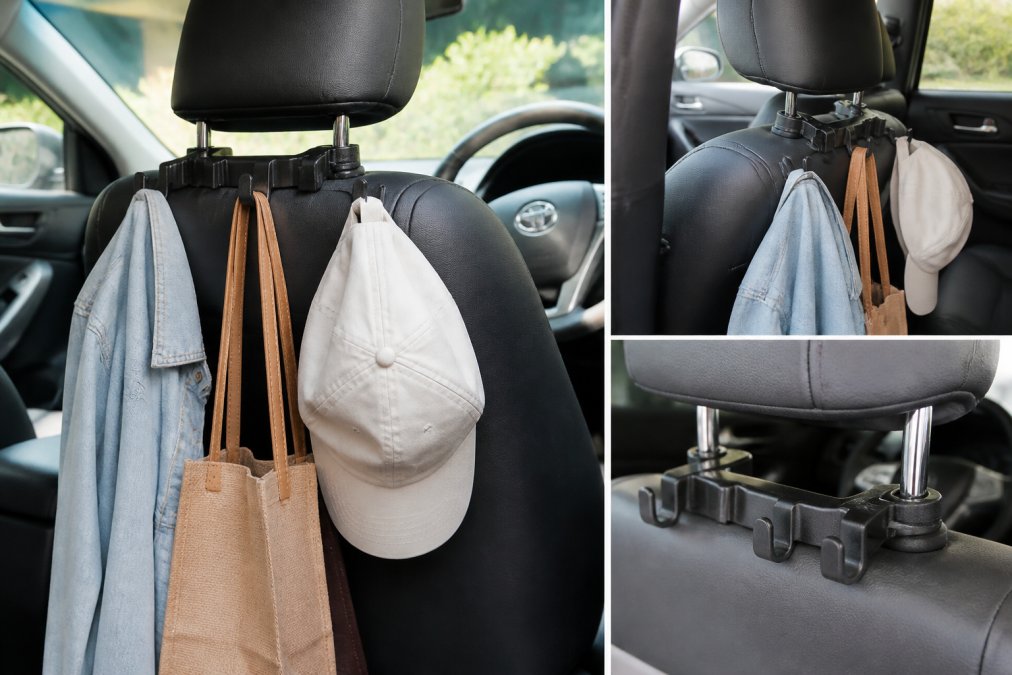 Close-up of a car headrest hook organizer with multiple items hanging from it including a light jacket, reusable shopping bag, and hat, mounted on the back of a front seat headrest in a sedan interior