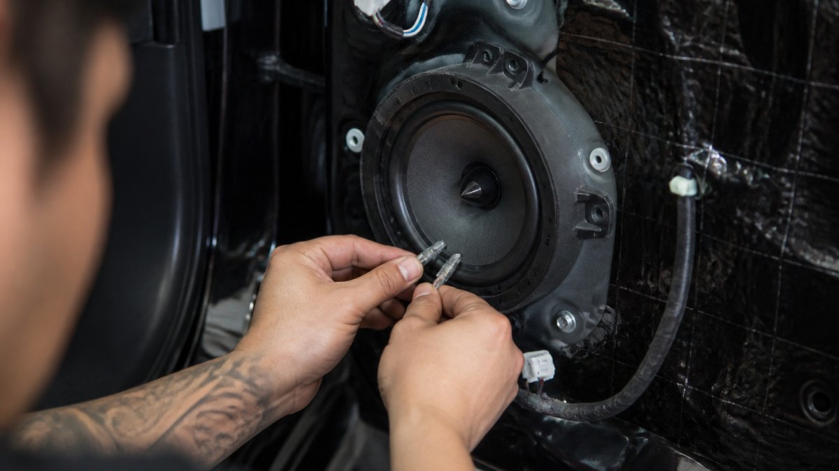Step-by-step diagram showing how to install the best car speakers into a vehicle door panel with proper wiring.