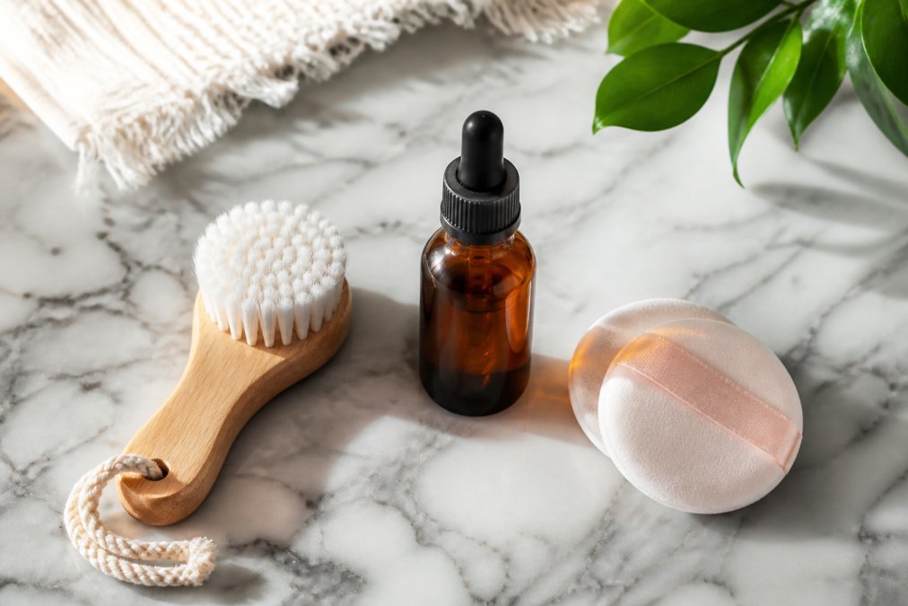 Turmeric serum, facial brush, and puff set for clean beauty brands on a marble counter