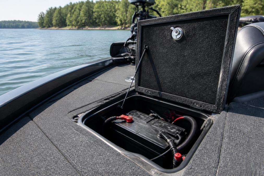 Diagram showing the installation process of a dual purpose battery inside a bass boat compartment