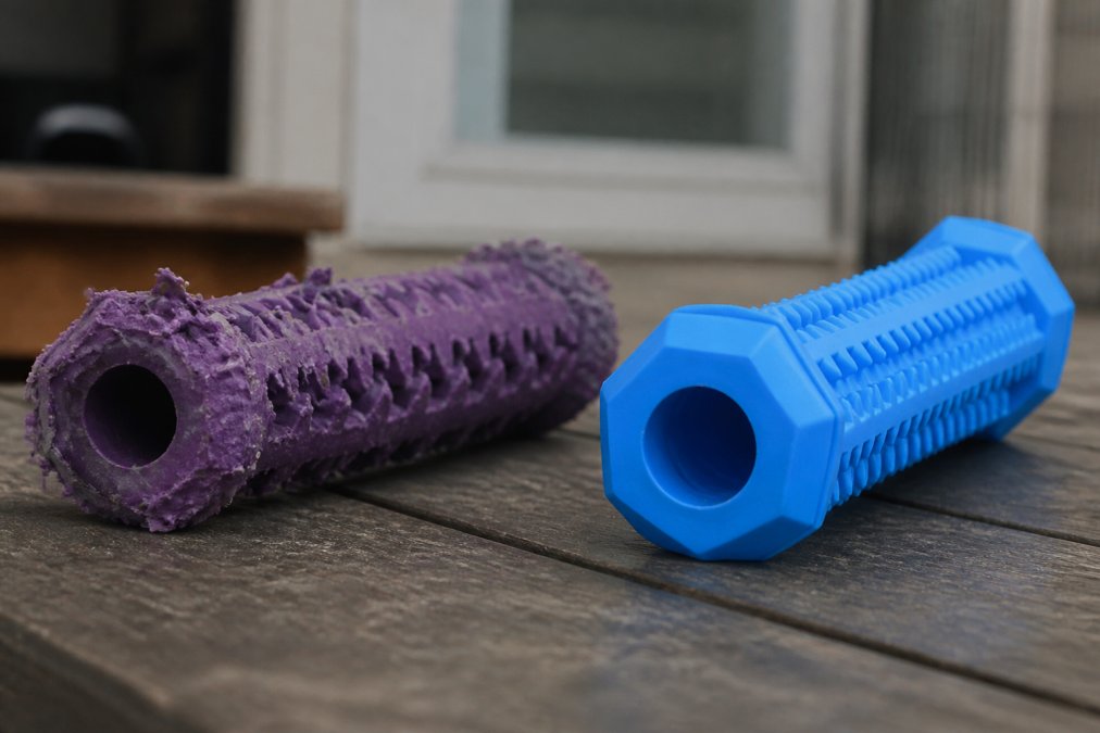 A worn, damaged chew toy with visible cracks, bristled edges, and deteriorated rubber next to a fresh new toy showing the dramatic difference in condition from aggressive chewing