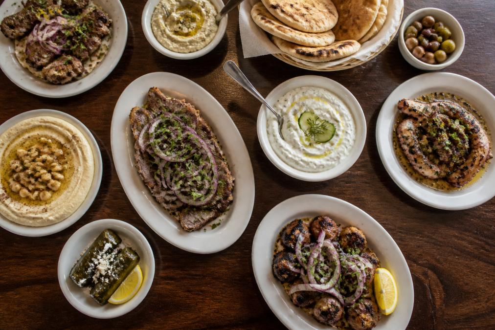 Infographic showing the best Greek restaurant in DC signature mezze dishes including hummus, tzatziki, and grilled meat.