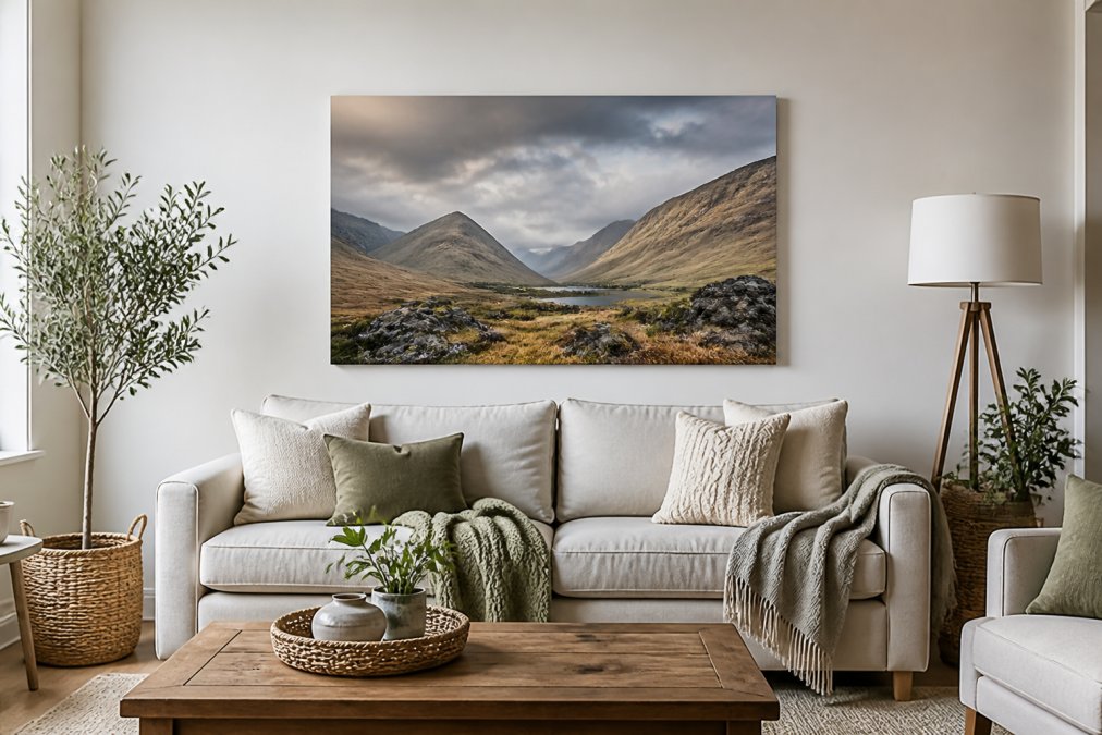 A bright, modern living room with a canvas print of a Highland landscape as the focal point above a neutral sofa, styled with soft throws and natural textures