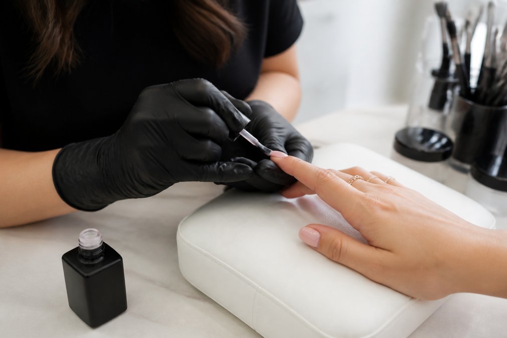 Step-by-step process infographic showing a technician applying sheer pink tinted builder gel to nails