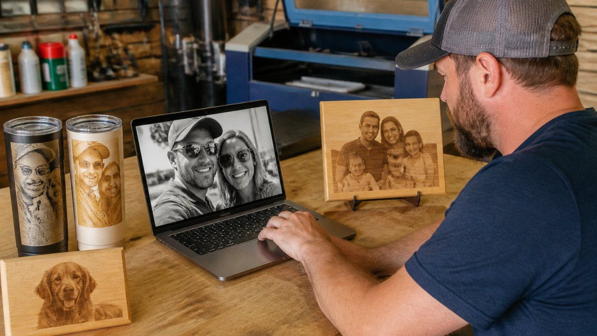 Maker performing laser file preparation on a laptop before engraving a wooden plaque in a workshop