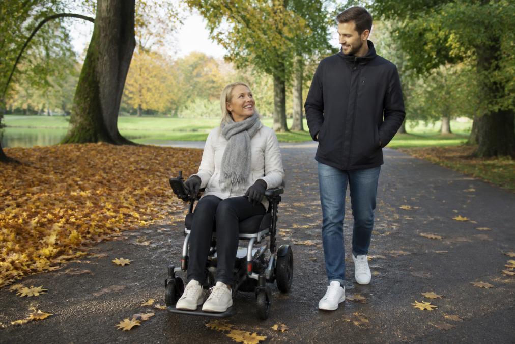 Professional illustration showing person and lightweight and folding concepts for folding powerchair