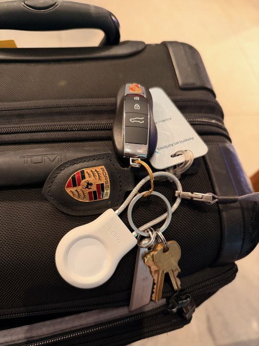 Keys and suitcase with luggage tracker