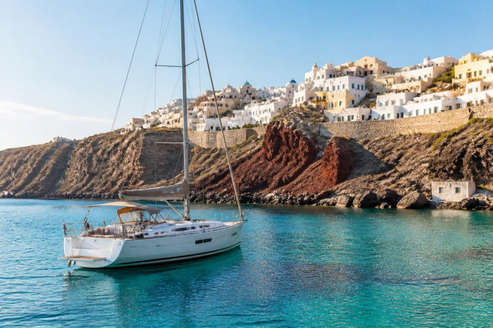 Luxury yacht anchored in turquoise waters off a Greek island, one of the best mediterranean islands for private yachting.