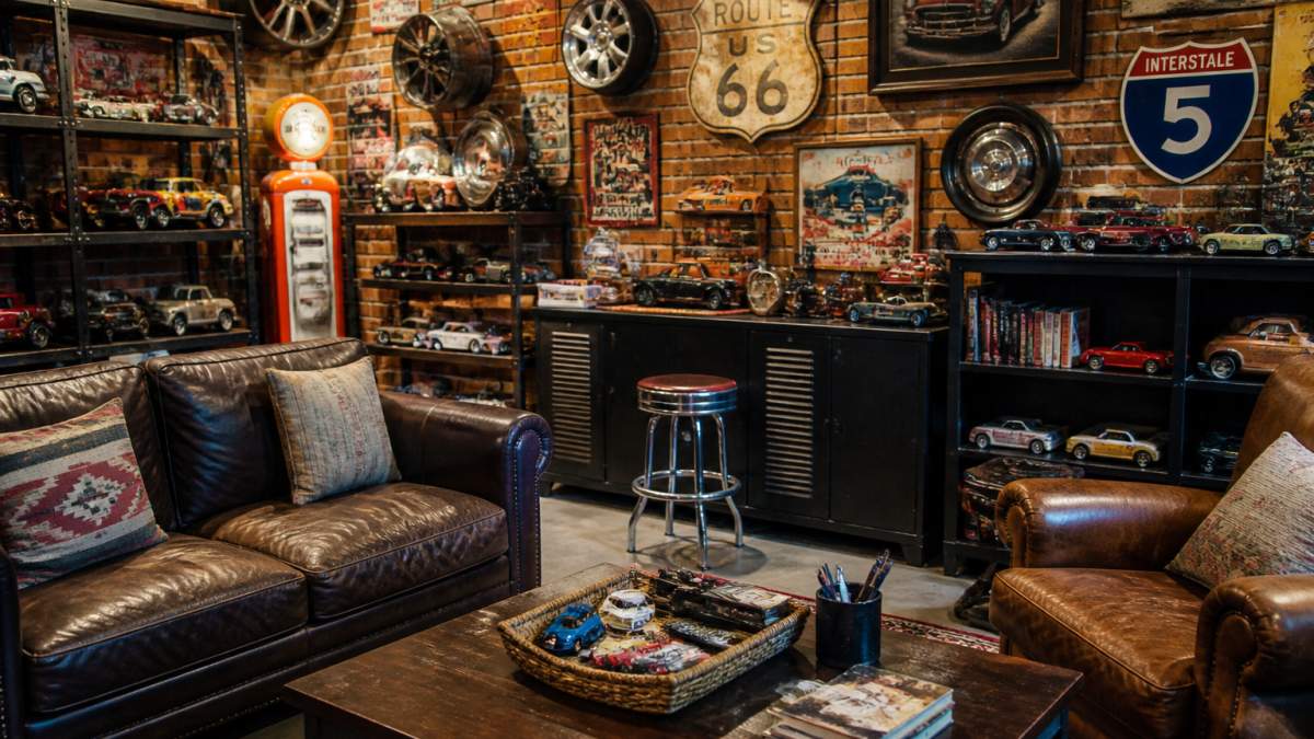 Vintage Route 66 signs and classic car memorabilia arranged on shelves in a stylish home den