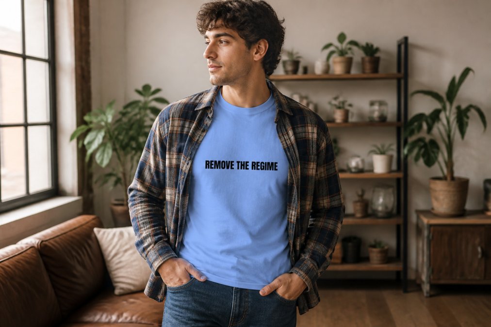 A person wearing a classic crew neck cotton t-shirt layered under an open flannel shirt, styled casually with jeans, photographed in warm natural indoor lighting showing fit and layering versatility