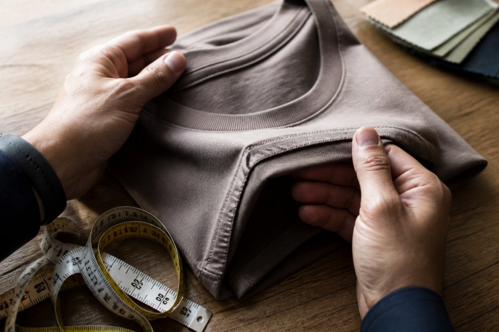 Process for checking the stitching and fabric of quality t-shirts using a measuring tape and swatches