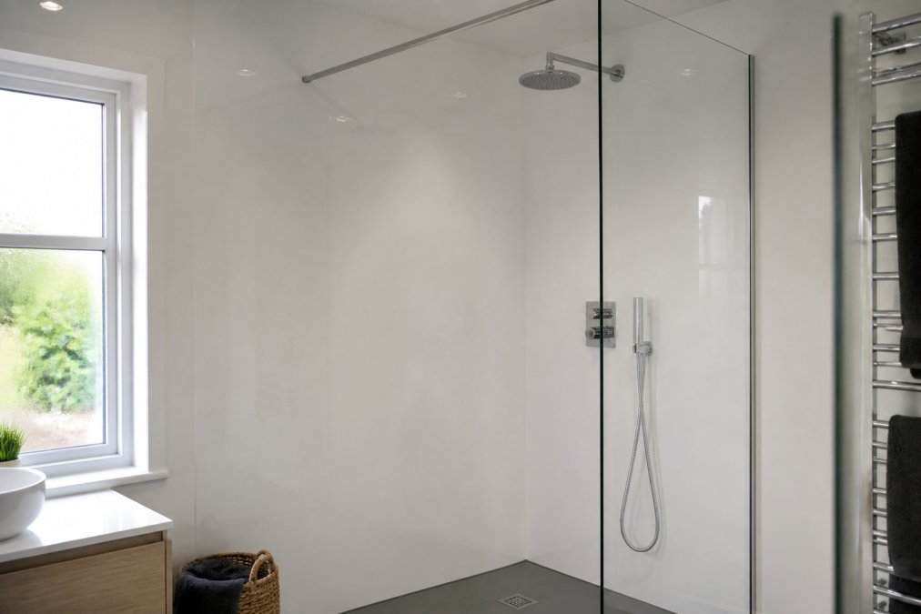 Modern bathroom with stone-effect shower enclosure wall panels installed floor-to-ceiling, showing a contemporary wet room with natural light streaming through a window and sleek chrome fixtures