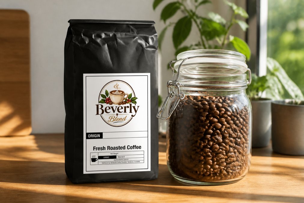 Close-up of freshly roasted coffee beans in a clear glass jar with roast date label visible, natural sunlight highlighting the beans' color and texture