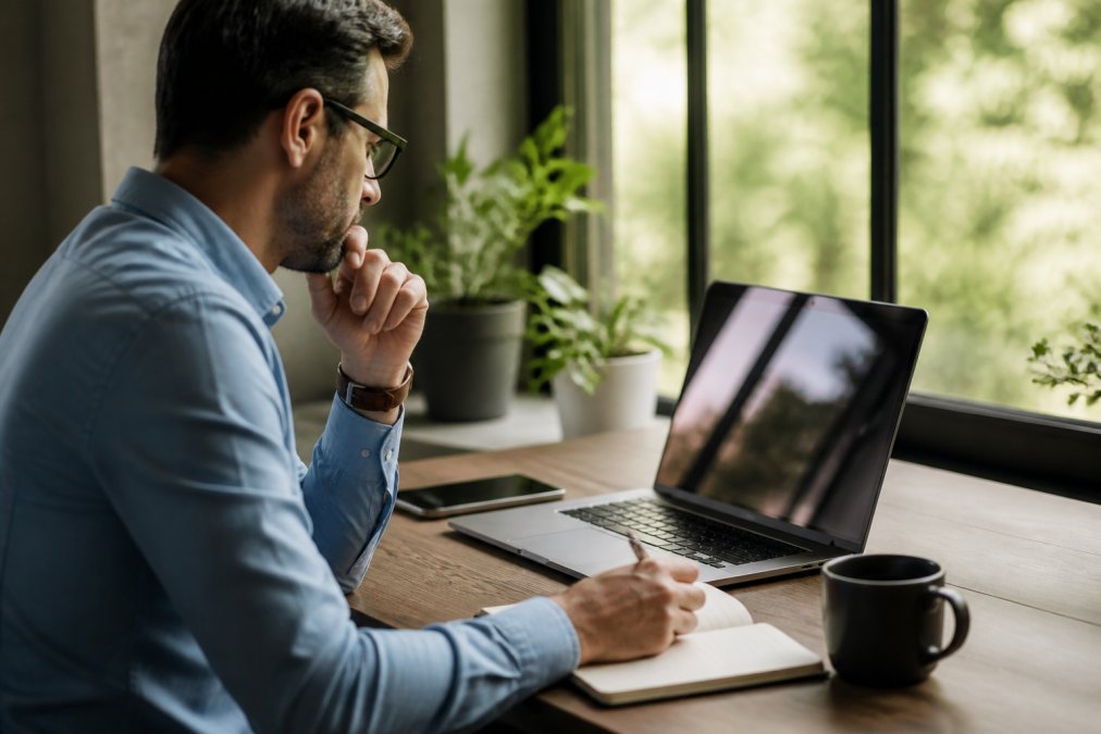 Professional reviewing a digital product sales dashboard on a laptop to find the best software for launching a digital