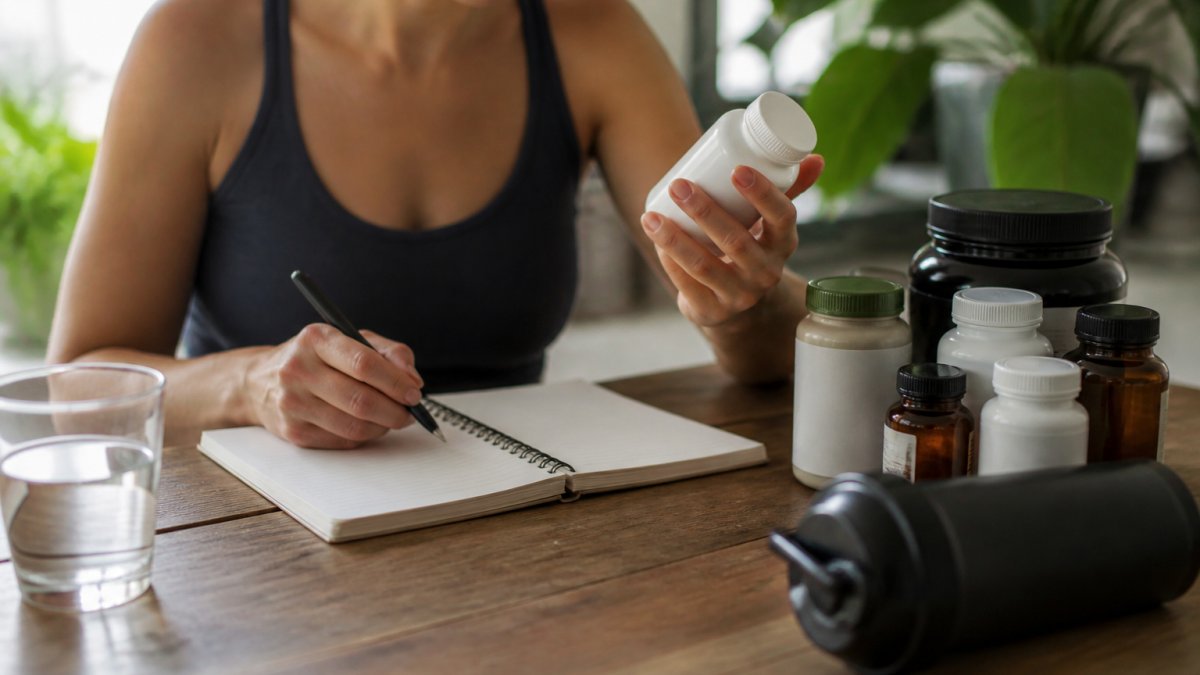 Checklist and supplement bottles on a table outlining safety steps for starting a new wellness routine